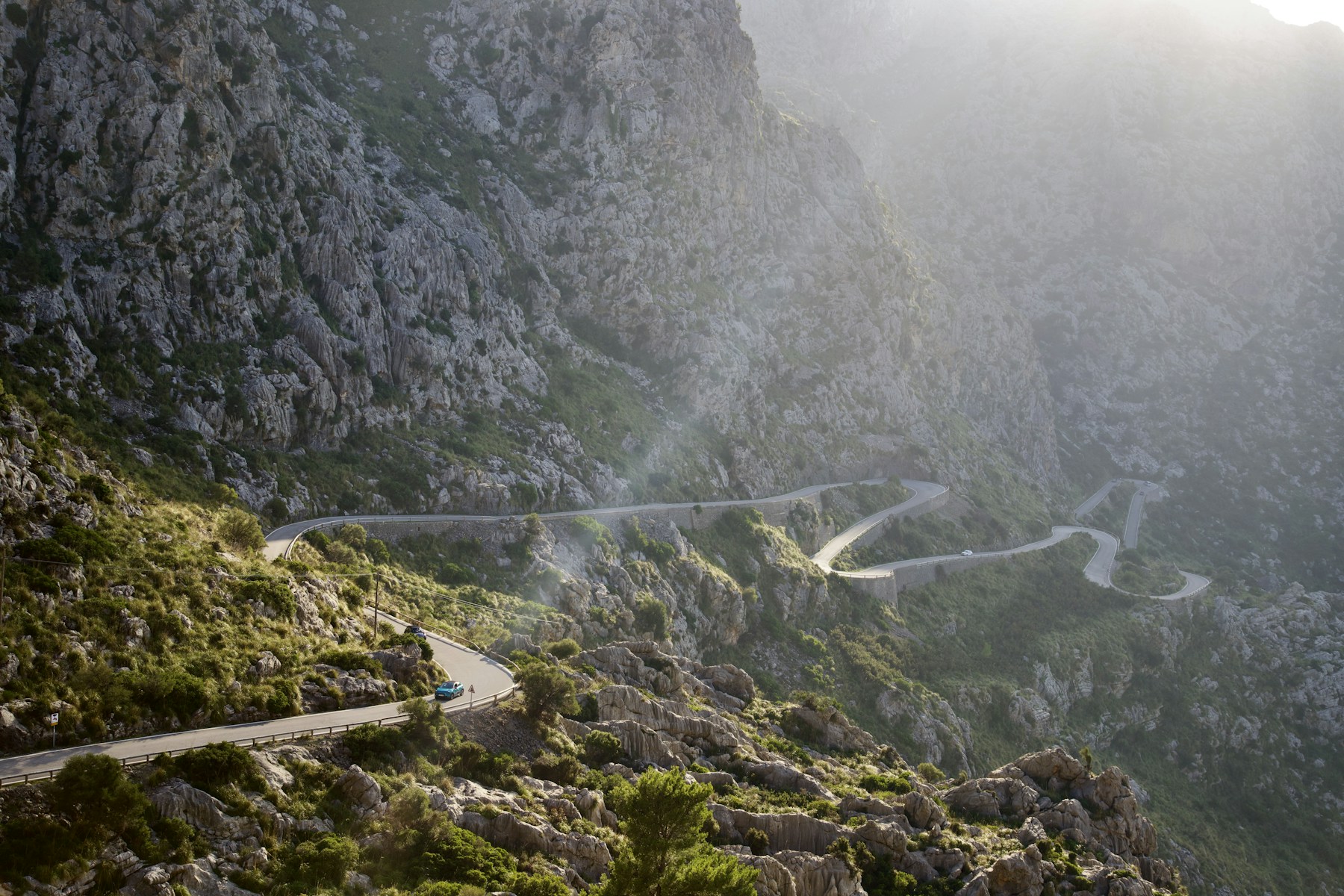 A winding mountain road through Mallorca's rocky countryside